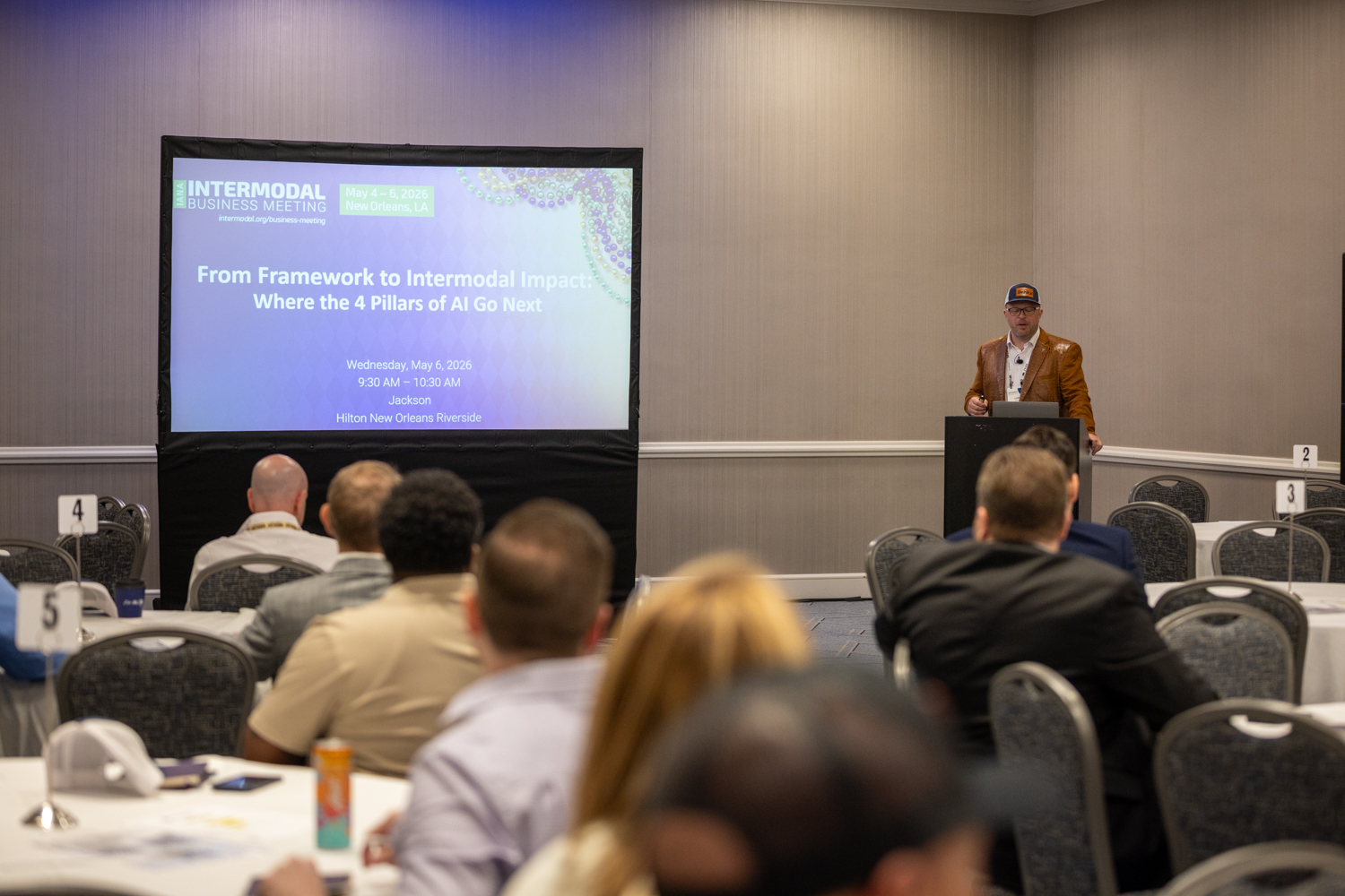 Chris Machut presenting 'From Framework to Intermodal Impact: Where the 4 Pillars of AI Go Next' at the IANA Intermodal Business Meeting, May 2026, Hilton New Orleans Riverside