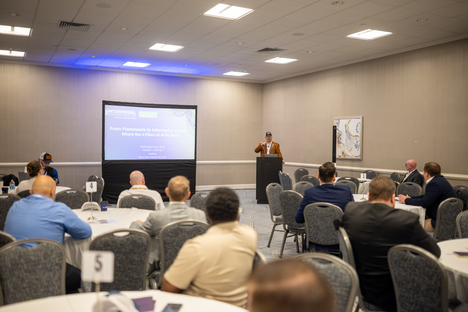 Chris Machut speaking to an audience of intermodal and supply chain industry leaders at the IANA Intermodal Business Meeting, May 2026, Hilton New Orleans