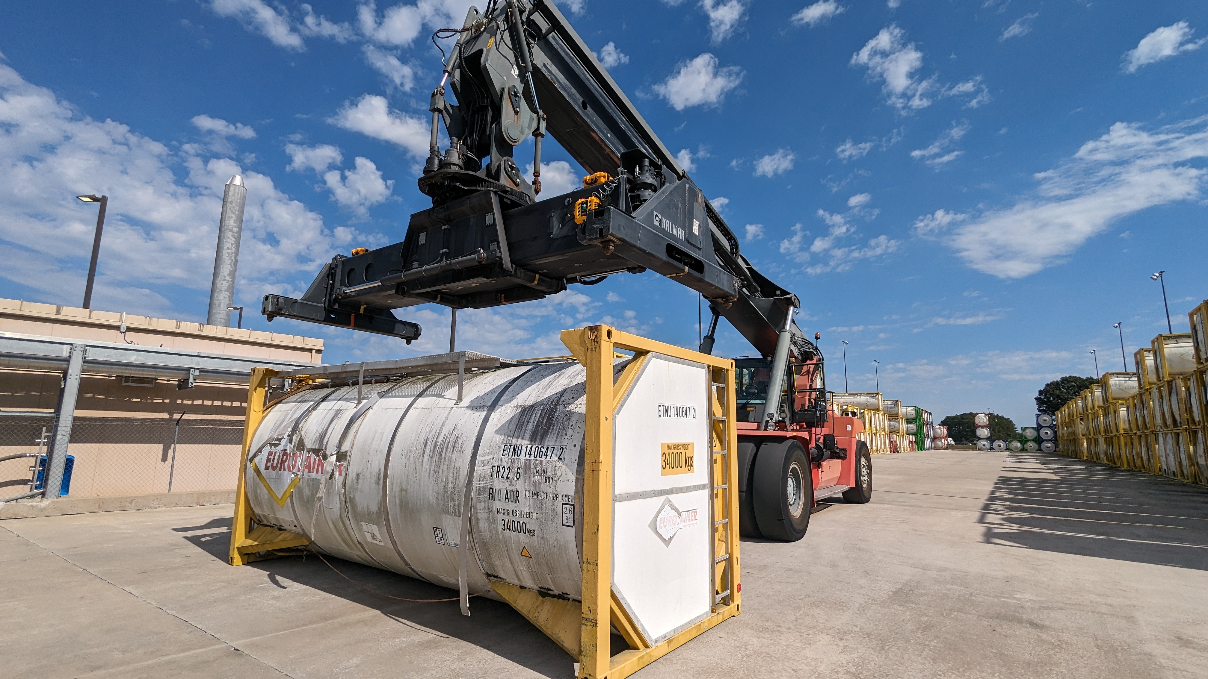 HoistCam on a spreader bar preparing to lift an ISO storage tank during intermodal operations